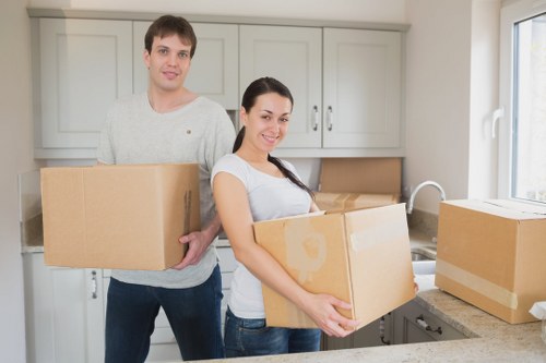 Movers handling furniture in a Wallington residential street