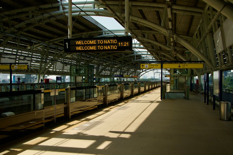 Inside a multi-level underground parking area near Wallington Station, with a staircase leading down to the pavement level where three individuals are walking. The environment features grey concrete w